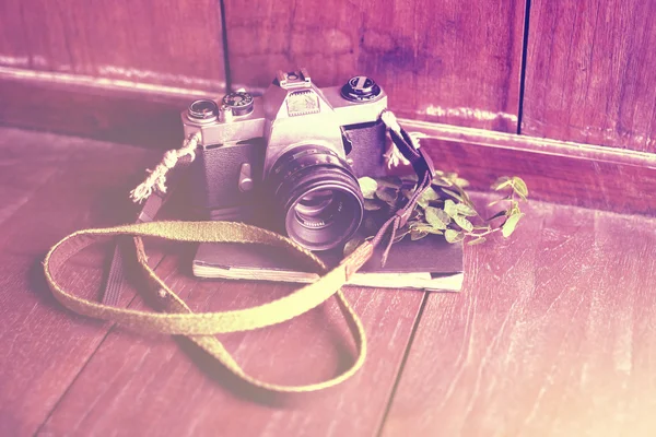 Old style camera with diary on a wooden floor, instagram photo e — Stock Photo, Image