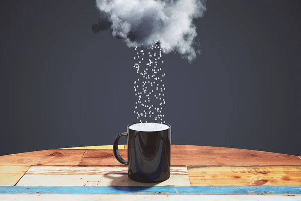 Rain comes from the cloud into black cup on the wooden table at — Stock Photo, Image
