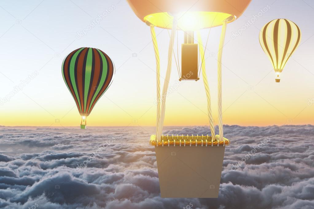 Flying baloons above clouds at sunset