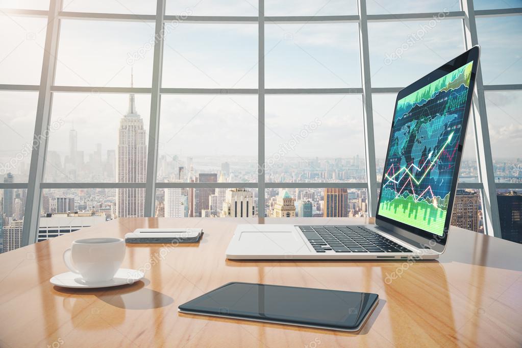 Sunny office with megapolis city view, digital tablet and laptop