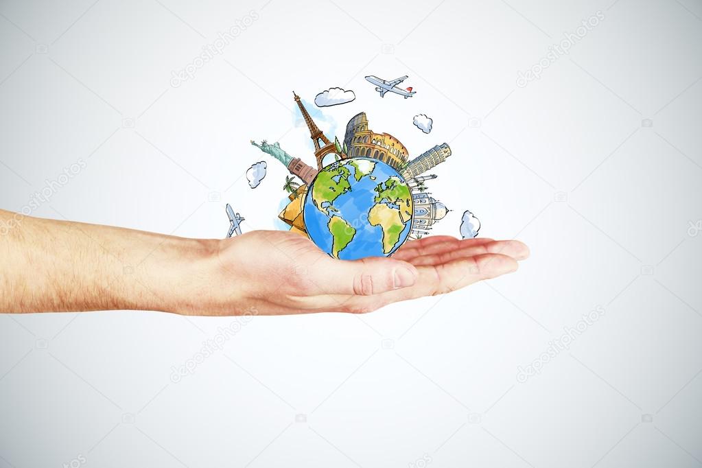 Travel concept with man hand and round earth with landmarks