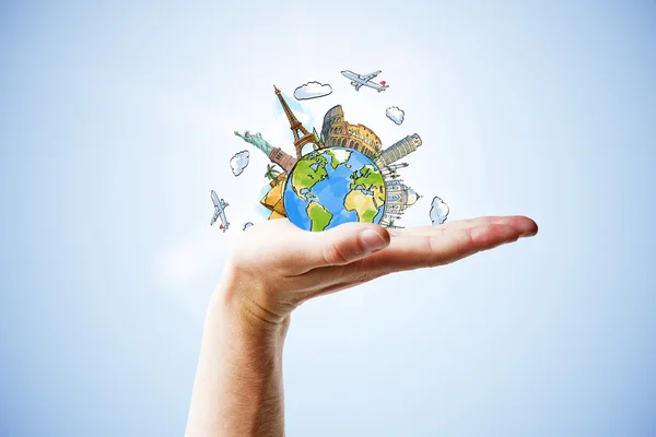 Hand and earth planet with landmarks — Stock Photo, Image