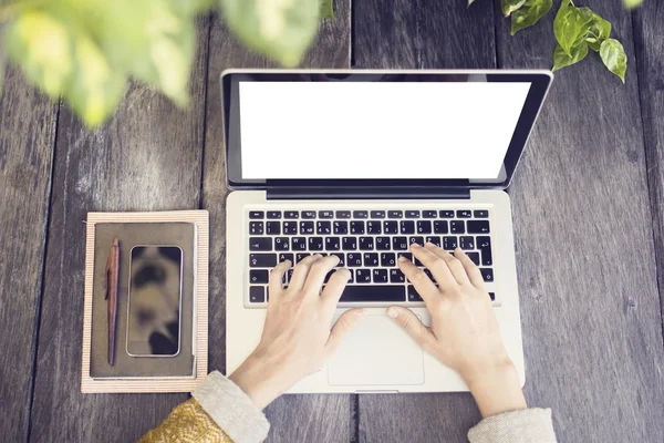 Hipeter girl with blank laptop screen, smartphone and diary on w — Stock Photo, Image