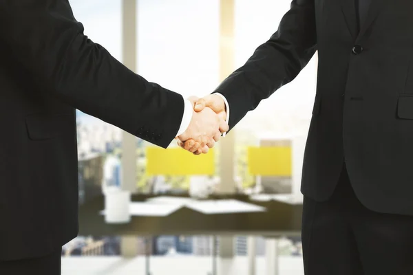 Businessmen shake hands in office — Stock Photo, Image