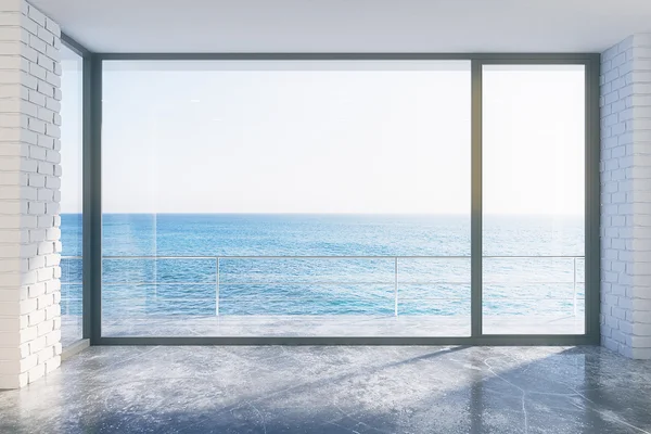 Estilo loft vazio com piso de concreto e vista para o mar — Fotografia de Stock