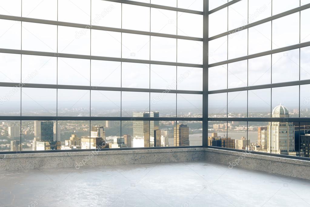 Empty loft room with windows in floor and city view