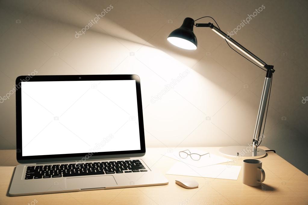 Blank white laptop screen with lamp on wooden table, mock up