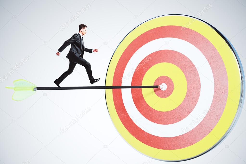 Businessman moving toward its goal of an arrow concept