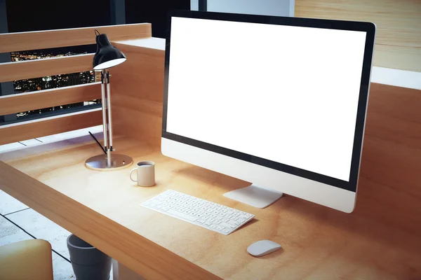 Blank vit datorskärm med lampa på träbord på höjd, — Stockfoto