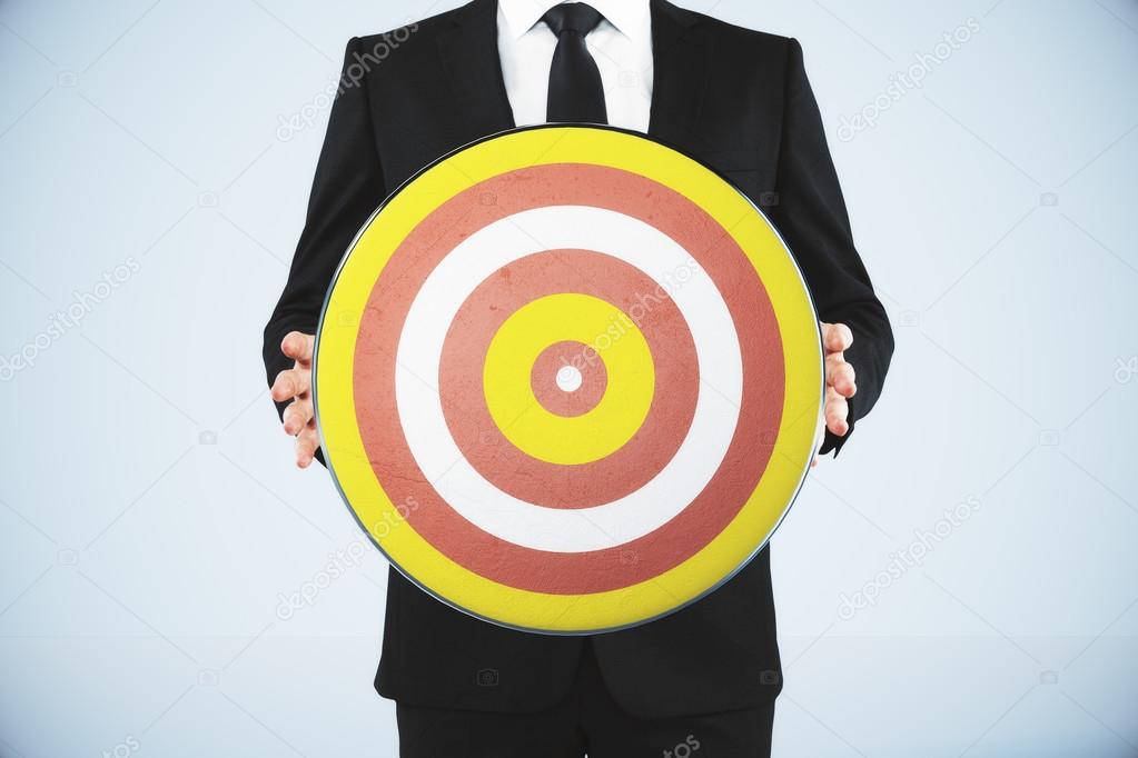 Bull's-eye concept with businessman holds a dart