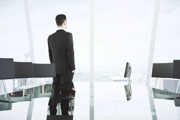 Businessman in modern light conference room with glass table, ch — Stock Photo, Image