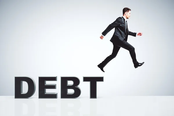 Koncept dluhu s podnikatelem uteče z dluhů — Stock fotografie