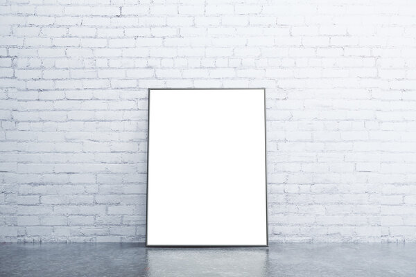 Blank white picture frame on concrete floor in empty room with white brick wall, mock up