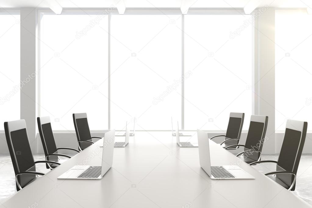 Empty conference table with a laptop and chairs and a large wind
