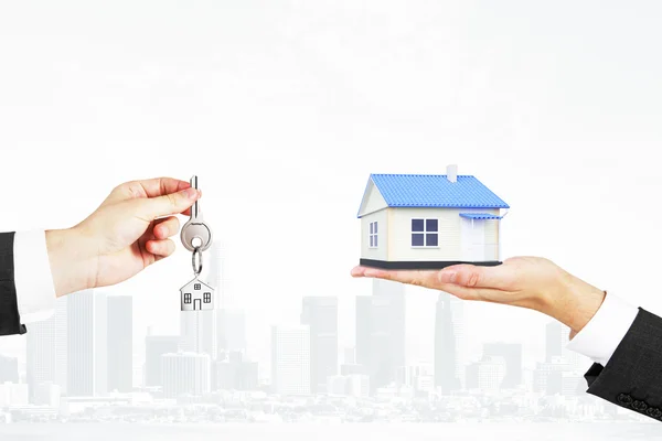 Selling real estate concept with a house and key — Stock Photo, Image