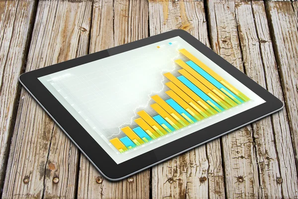 Dagital tablett med business diagram på träbord — Stockfoto