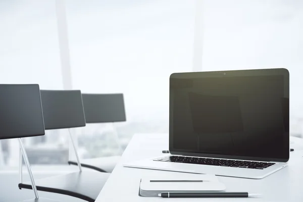 Leerer schwarzer Laptop-Bildschirm auf weißem Tisch im Konferenzraum mit — Stockfoto