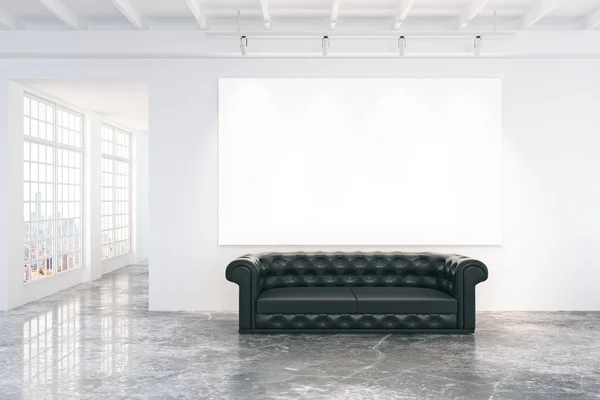 Blank white poster on white wall with black leather sofa on conc — Stock Photo, Image