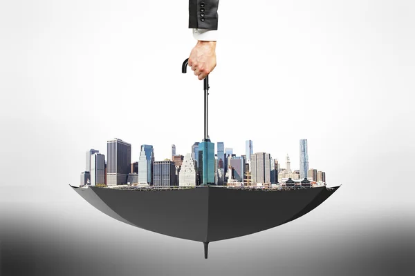 City district area in black flipped over umbrella and man hand — Stock Photo, Image