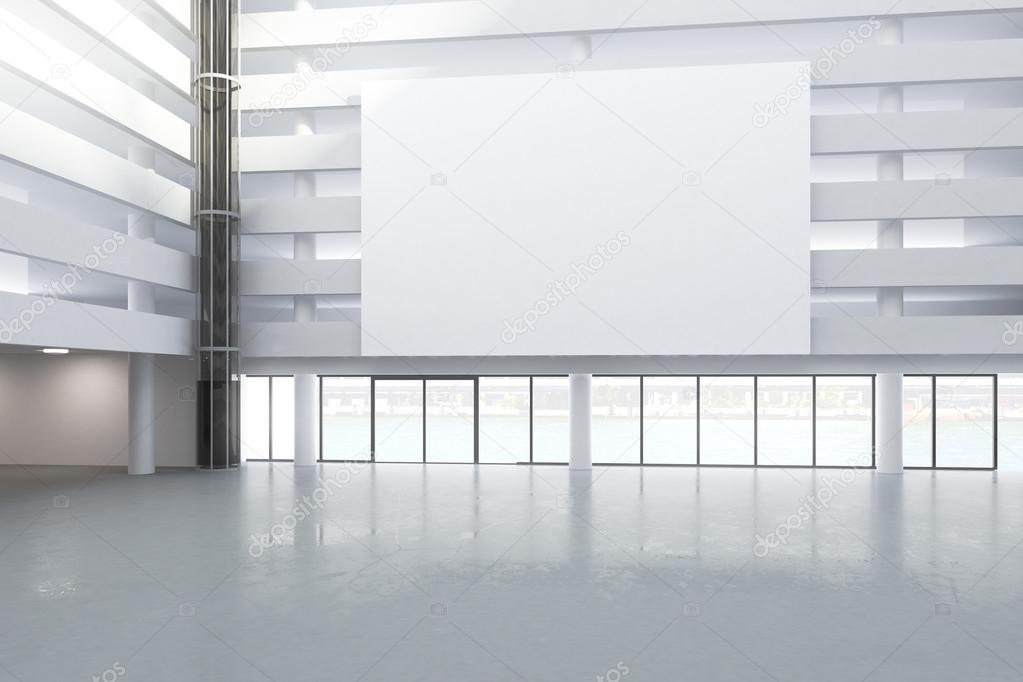 Blank white billboard in the hall of empty building with concret