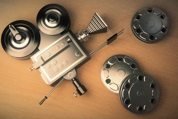 Top view of an old movie camera and film cartridge on a wooden t — Stock Photo, Image