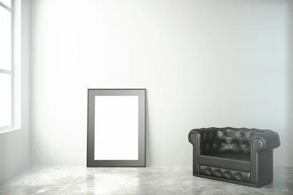 Blank black picture frame on concrete floor with leather chair i — Stock Photo, Image
