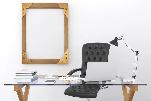 Work desk with a laptop and a blank picture frame on the wall, m — Stock Photo, Image