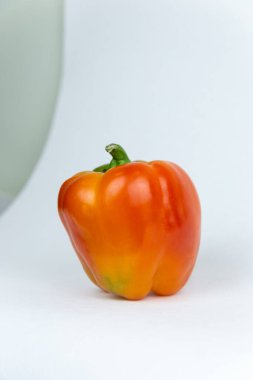 Taze sebzeler, yeşil saplı sulu kırmızı biberler izole edilmiş beyaz bir zemin üzerinde duruyor ve yazı için bir yer var. Ön manzara. Taze sebze..