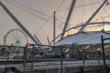 2020-09-19 19: Il Grande Bigo and Ferris Wheel in Porto Antico di Genova or Old port of Genoa, Liguria region, Italy clipart