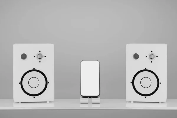 Smartphone mockup in the middle between white stereo music speakers. White screen of a smartphone for your design of a music application or advertisement on a background of white music speakers. 3D rendering.