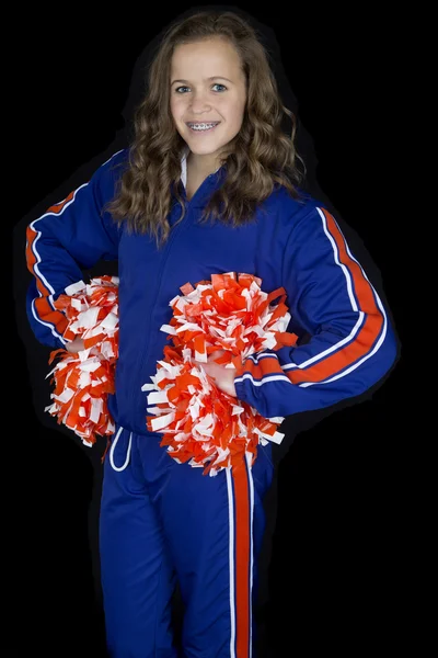 Niedliche High School Cheerleader stehen in einem blau-orangen Stockbild