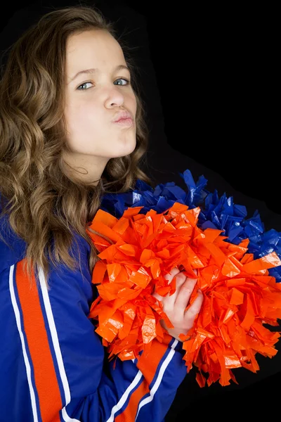 Bonito vista lateral de adolescente cheerleader puckering lábios beijando olhos o Fotografias De Stock Royalty-Free