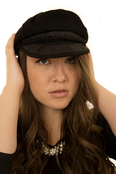 Woman wearing black hat with a somber look — Stock Photo, Image