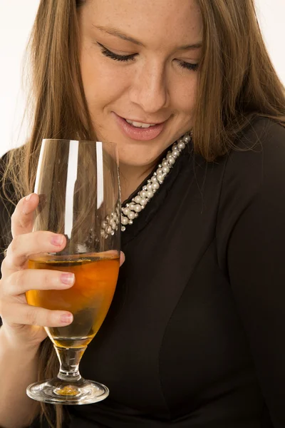 Woman holding wine glass and looking down smiling — Stock Photo, Image