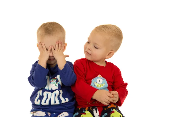 Two cute boys playing together wearing winter pajamas — Stock Photo, Image