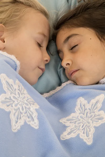 Portrait of two beautiful young girls asleep in bed — Stock Photo, Image