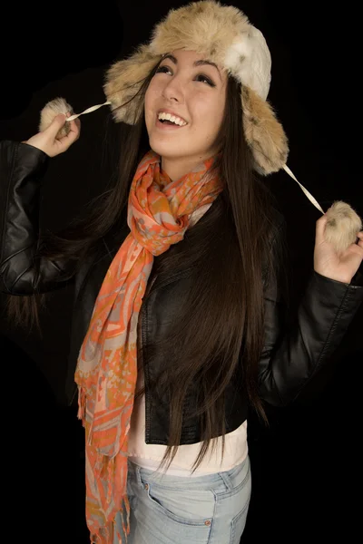 Pretty Asian American girl pulling fur hat strings looking up — Stock Photo, Image