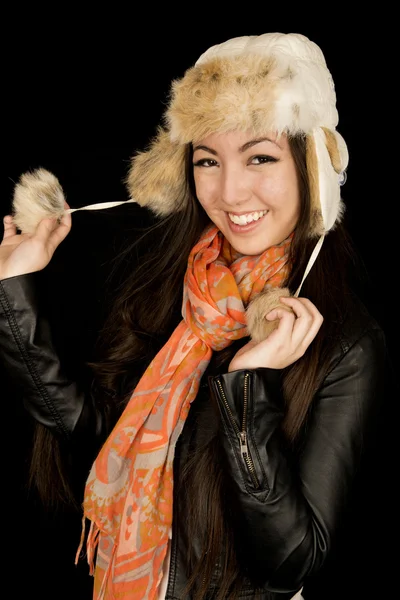 Cute Asian Caucasian girl pulling fur hat strings smiling — Stock Photo, Image