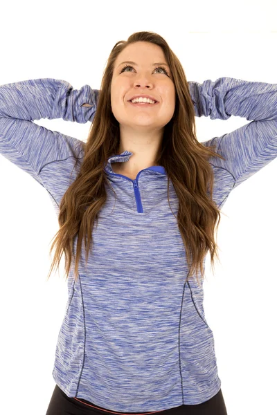 Female model with her arms behind her head stretching smiling — Stock Photo, Image