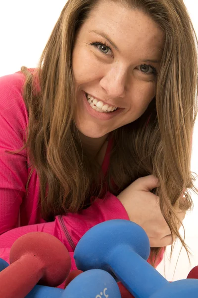 Cute woman model close-up leaning by colorful barbells — Stock Photo, Image