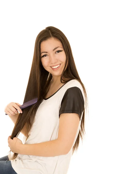 Happy Asian American young teen girl brushing her hair — Stock Photo, Image