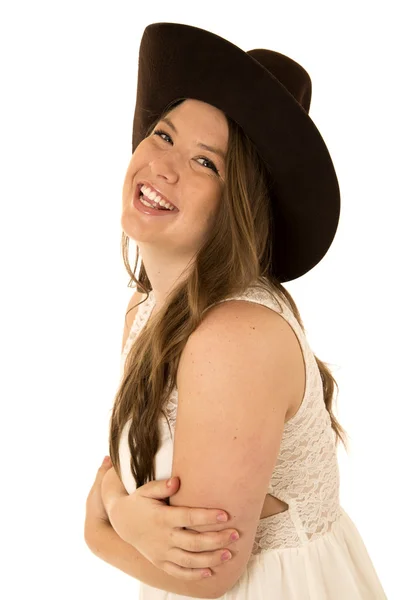 Cowgirl wearing a white dress with her arms folded laughing — Stock Photo, Image