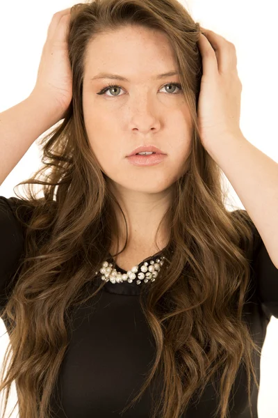 Young female model wearing a black dress with an intense look — Stock Photo, Image