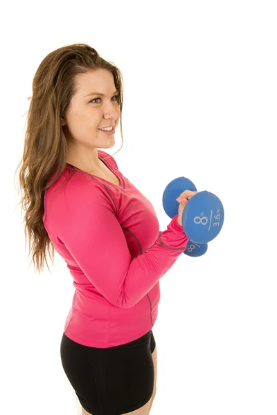 Sideview of an athletic young woman curling barbells — Stock Photo, Image