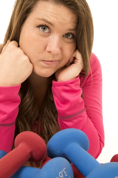 Porträt einer jungen Frau, die ratlos an Hanteln lehnt — Stockfoto