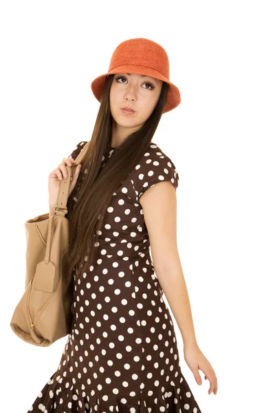 Daydreaming teen female model wearing a brown polka dot dress an — Stock Photo, Image