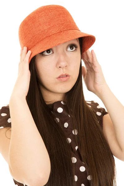 Cute teen girl model adjusting her orange hat wearing polka dot Stock Image