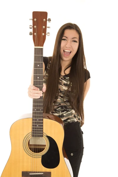 Excited female model holding out her acoustic guitar — Stock Photo, Image
