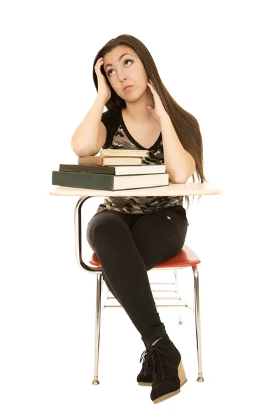 Attractive female student sitting at desk looking up — Stock Photo, Image