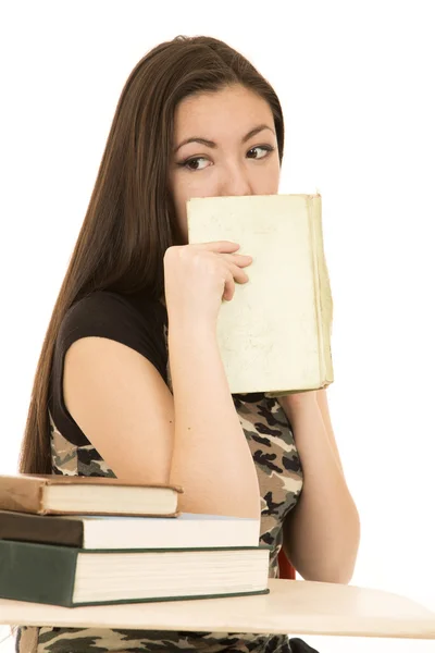 Asian American female student covering mouth with her book — Stock Photo, Image
